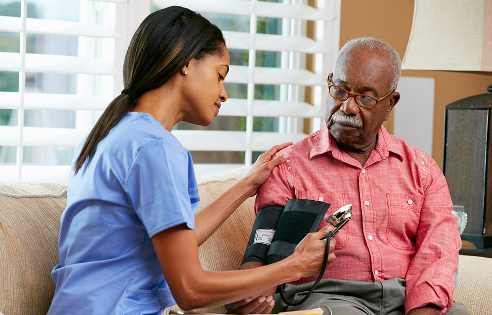 A specialist checking on a senior during a scheduled home visit